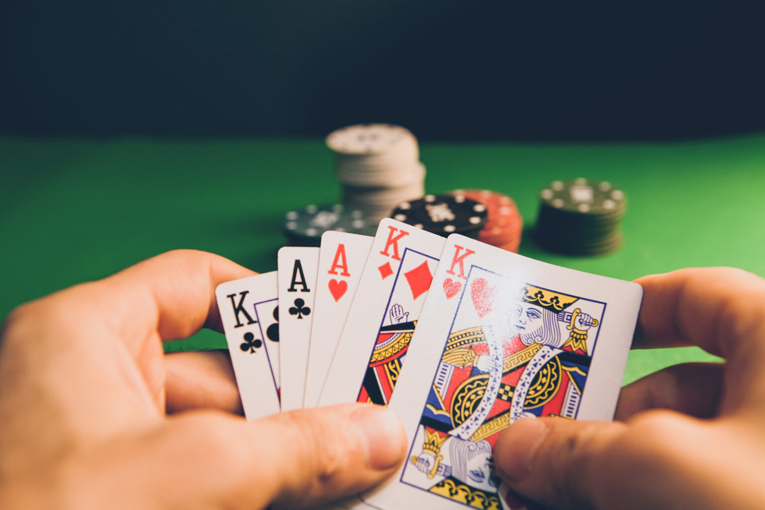Close-up illustration of playing cards and casino chips in warm tones.